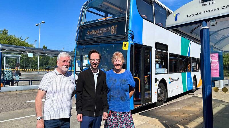 Cllr Kurtis Crossland in front of a bus with ward colleagues Cllr Bob McCann and Cllr Ann Woolhouse