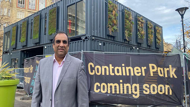 Cllr Shaffaq Mohammed standing in front of the Fargate Containers