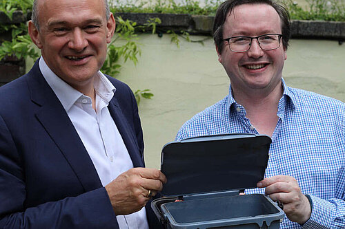 Cllr Joe Otten and Ed Davey MP with a food waste recycling caddy