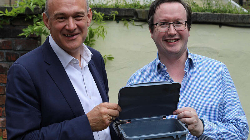 Cllr Joe Otten and Ed Davey MP with a food waste recycling caddy