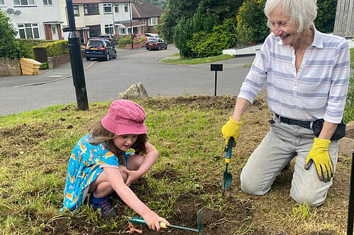 Cllr Barbara Masters planting wildflowers