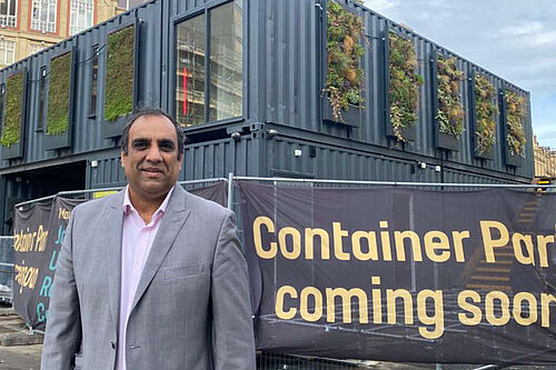 Cllr Shaffaq Mohammed standing in front of the Fargate Containers